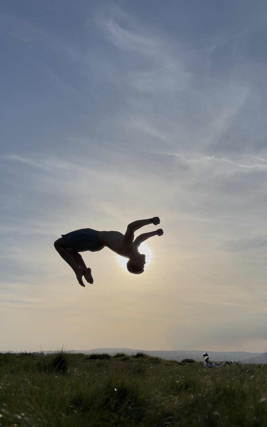 Henry mid-backflip at sunset
