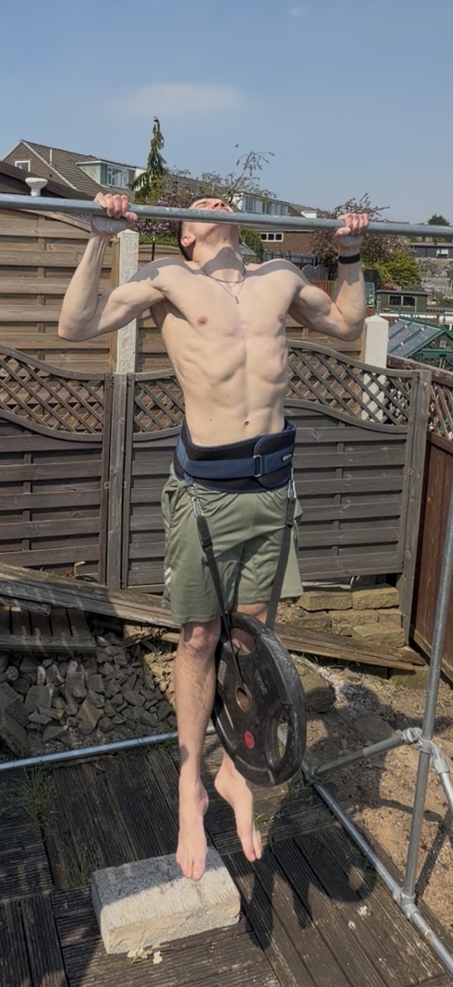 Henry performing a weighted pull-up